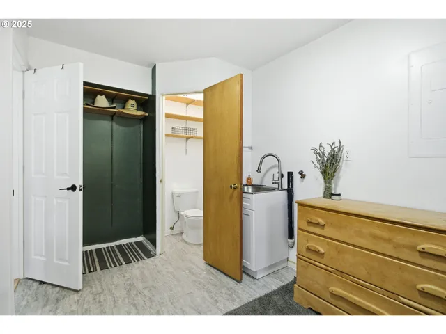 a view of kitchen with sink and refrigerator