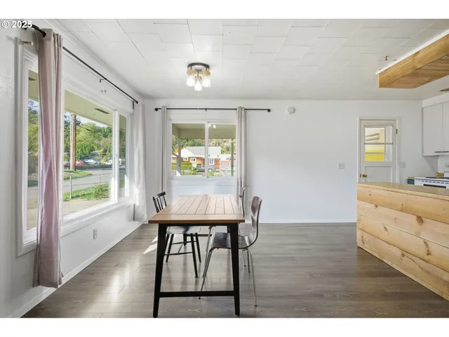 a view of kitchen with furniture window and wooden floor