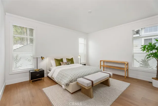 a kitchen with stainless steel appliances kitchen island granite countertop a refrigerator a stove and a sink with wooden floor