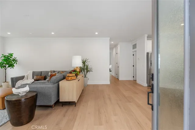 a living room with furniture and view of kitchen