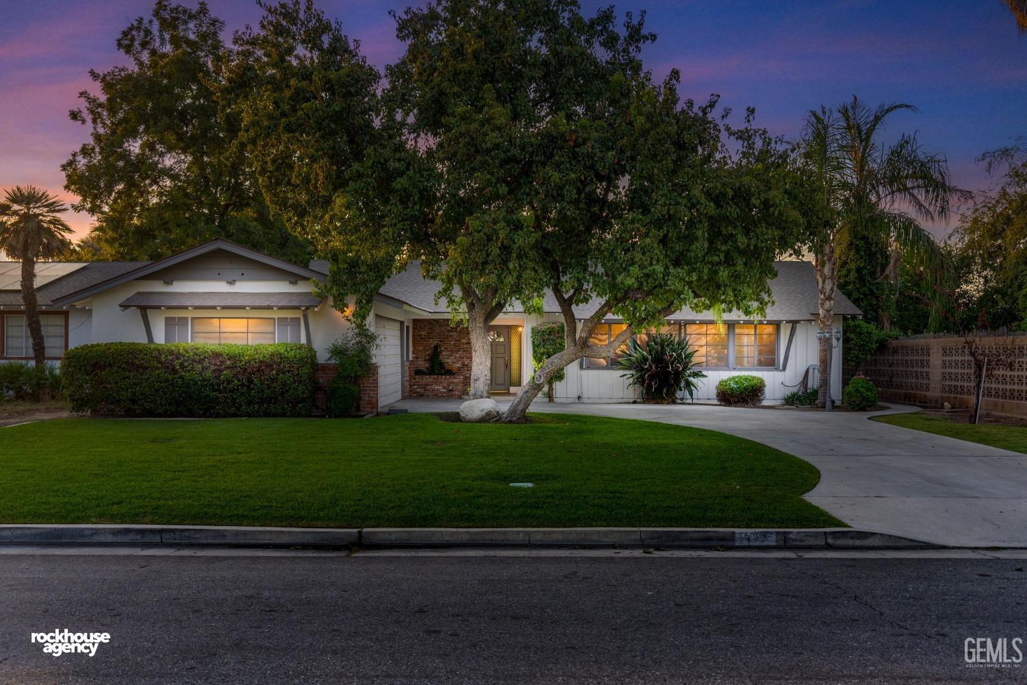 Undisclosed Address Bakersfield, CA 93309 - Photo 1 of 23 a front view of a house with a garden