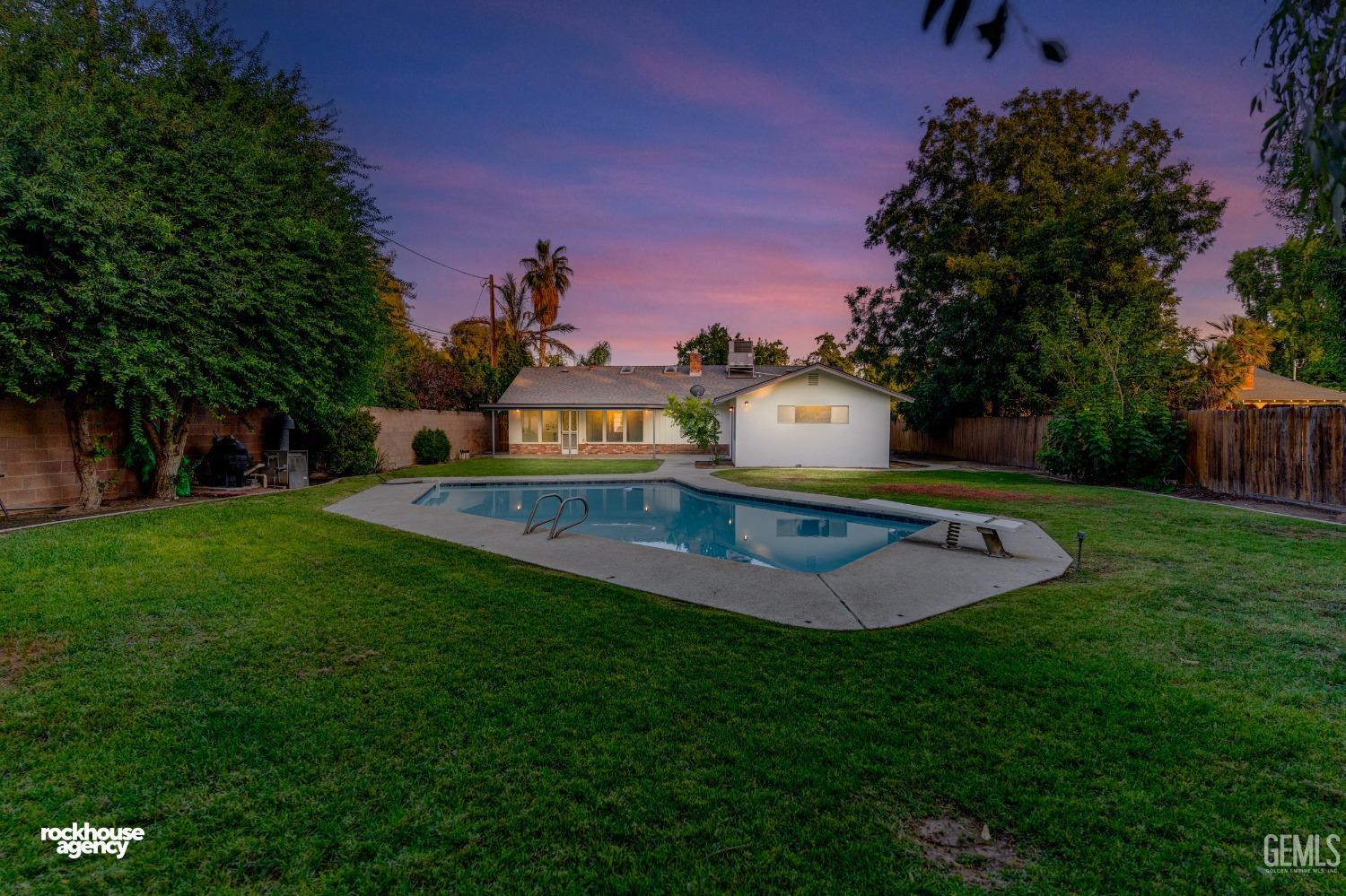 Undisclosed Address Bakersfield, CA 93309 - Photo 21 of 23 a view of a swimming pool with a yard