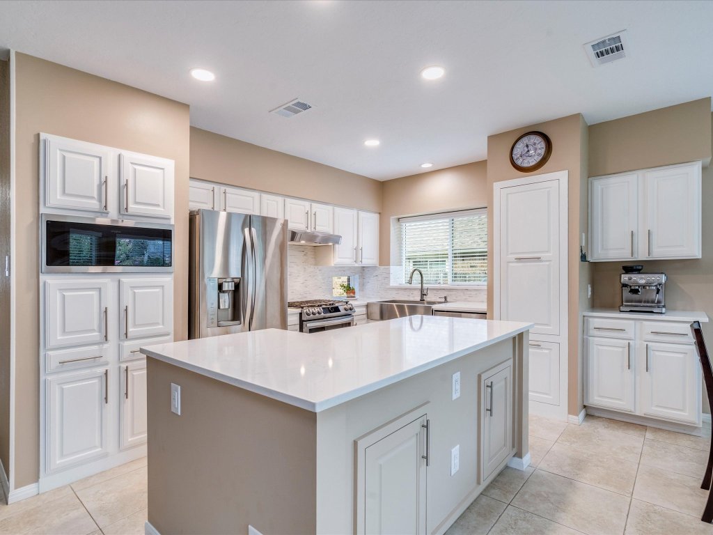 1110 Quail Lane Round Rock, TX 78681 - Photo 1 of 1 a large kitchen with cabinets stainless steel appliances and a counter space