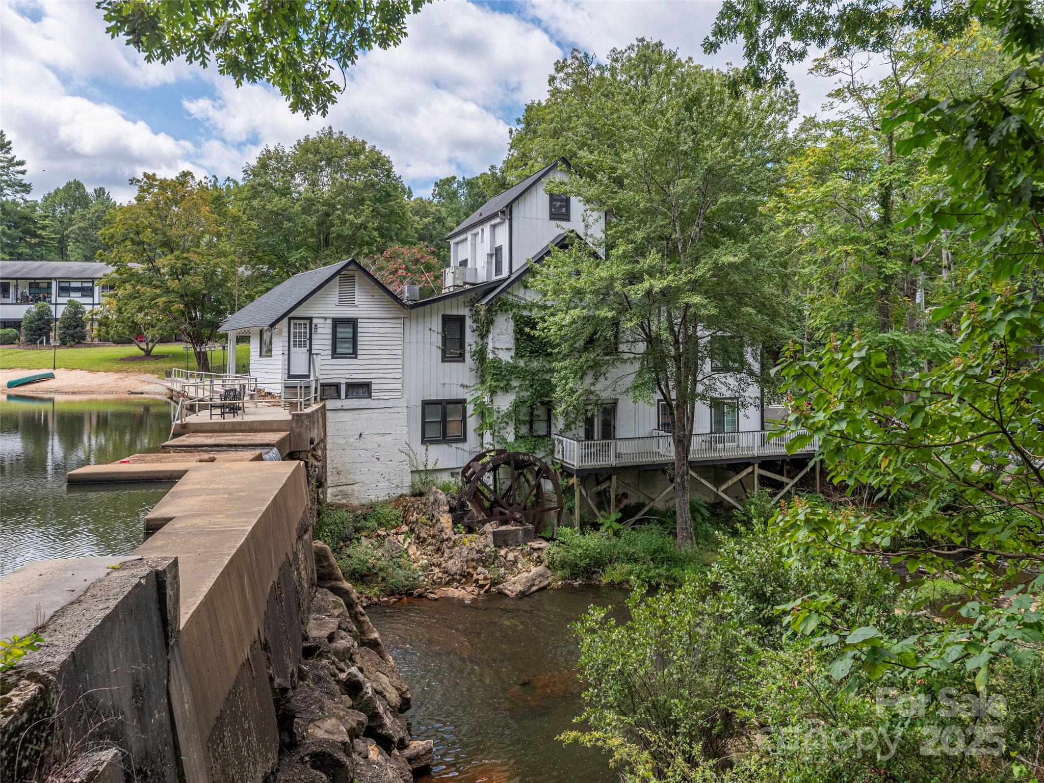 1150 West Blue Ridge Road, Unit 103 Flat Rock, NC 28731 - Photo 13 of 27 a view of a house with a yard and sitting area