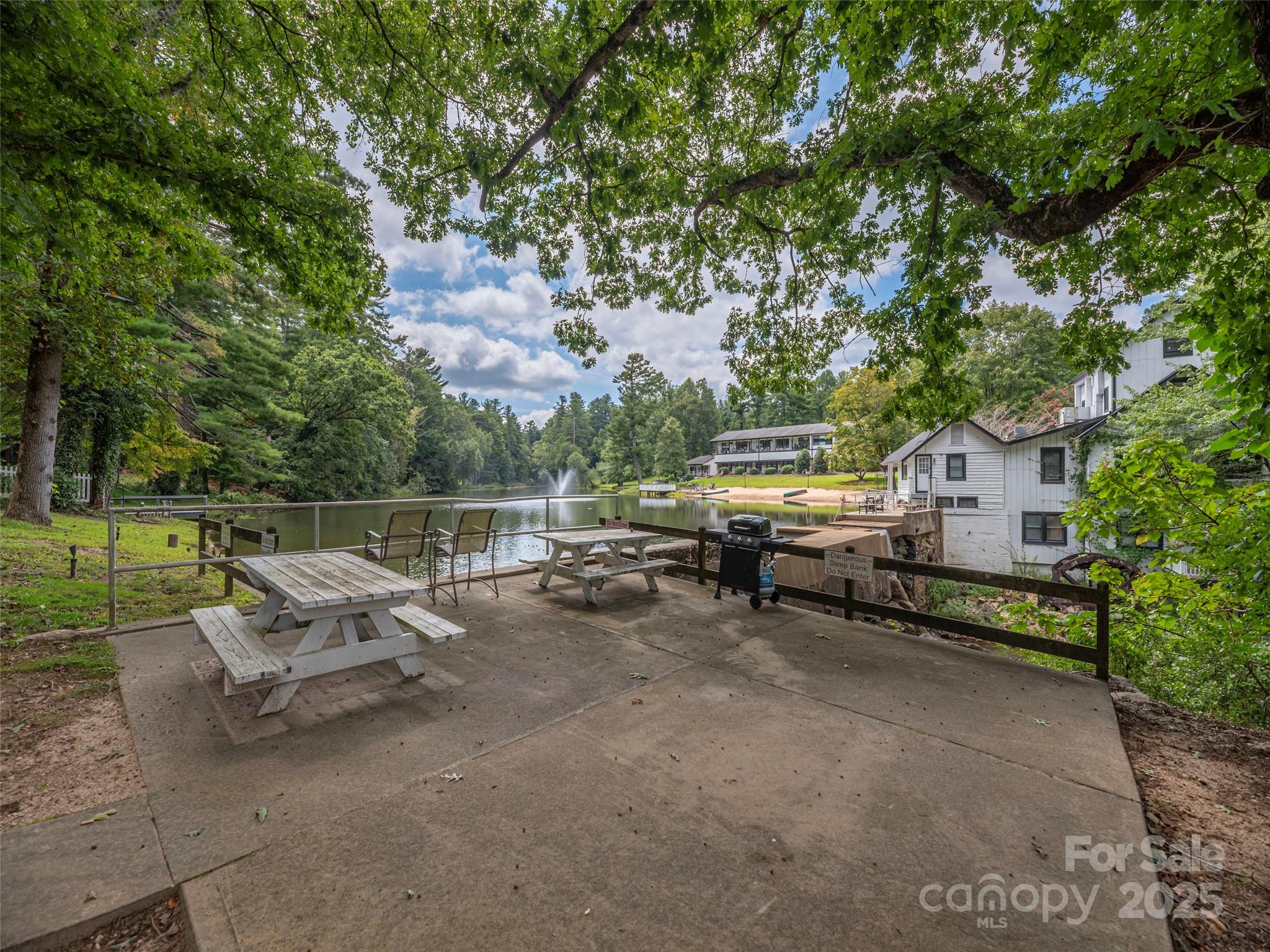 1150 West Blue Ridge Road, Unit 103 Flat Rock, NC 28731 - Photo 15 of 27 a view of a bench in a backyard