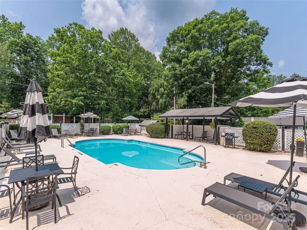 a view of a house with swimming pool and porch