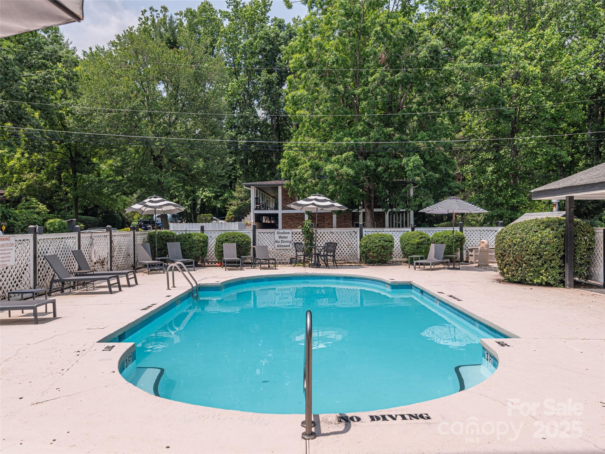1150 West Blue Ridge Road, Unit 103 Flat Rock, NC 28731 - Photo 19 of 27 a view of a swimming pool with a patio