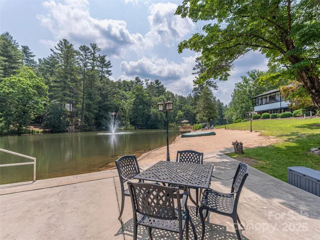 a view of a lake with table and chairs