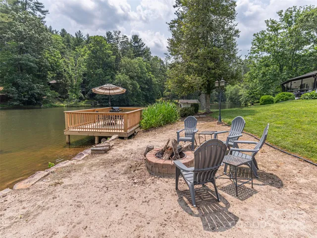 a patio with water view fountain and a fire pit