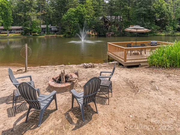 a view of a lake with table and chairs