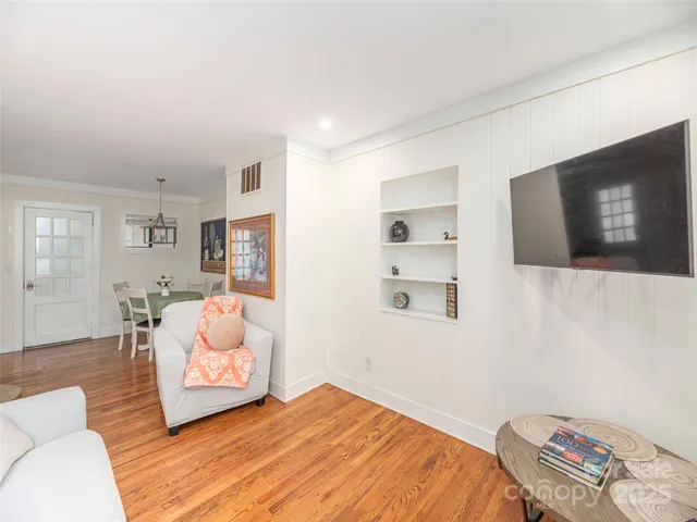 a bedroom with a bed and flat screen tv