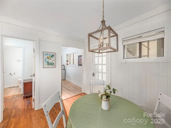 a view of dining room and hall with wooden floor