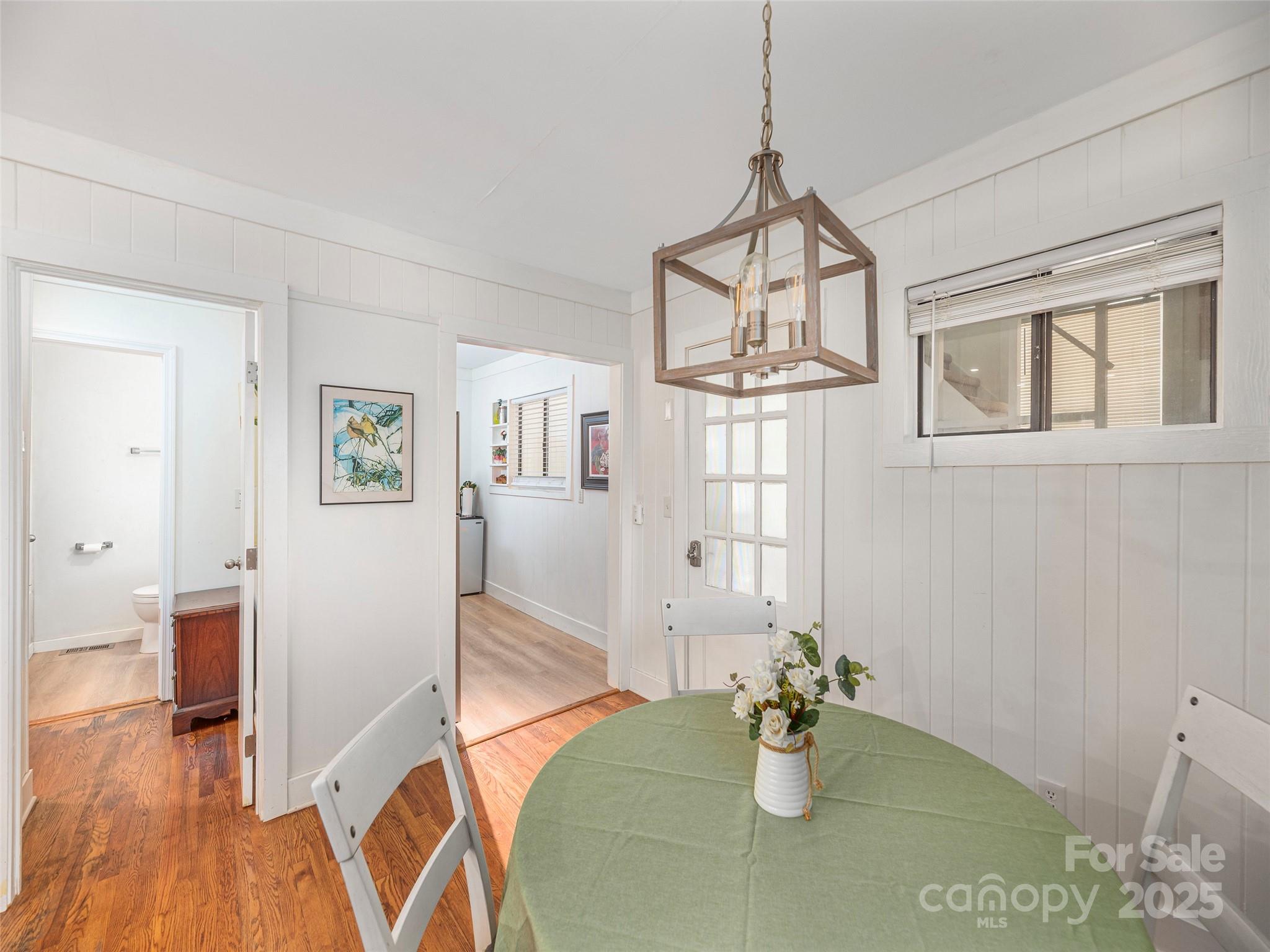 1150 West Blue Ridge Road, Unit 103 Flat Rock, NC 28731 - Photo 6 of 27 a view of dining room and hall with wooden floor