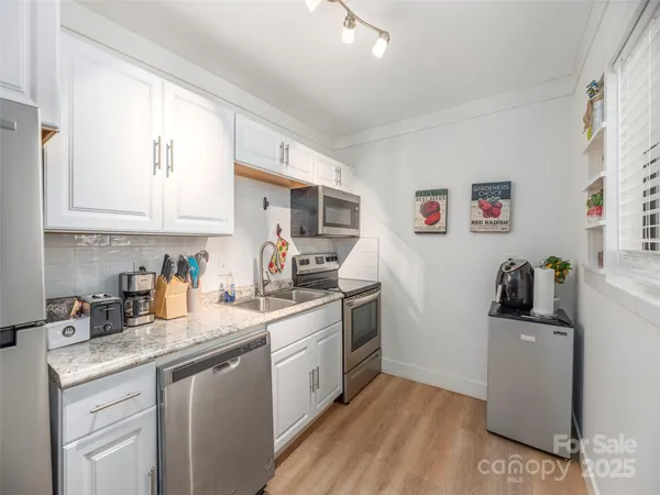 a kitchen with a sink cabinets and window