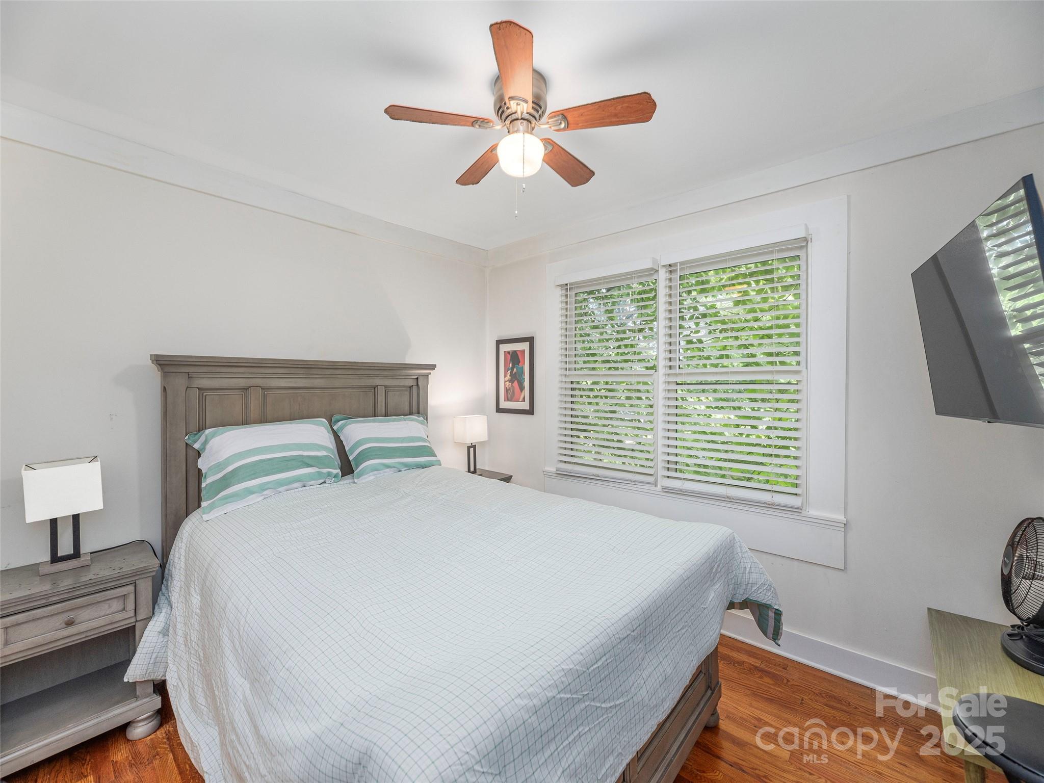 1150 West Blue Ridge Road, Unit 103 Flat Rock, NC 28731 - Photo 8 of 27 a bedroom with a bed and a large window with the outer view