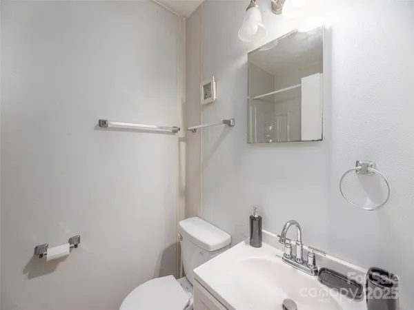 a bathroom with a sink mirror and toilet