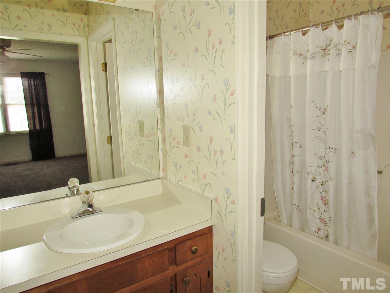 3025 Old Crews Road Raleigh, NC 27616 - Photo 22 of 25 a bathroom with a granite countertop sink toilet and shower