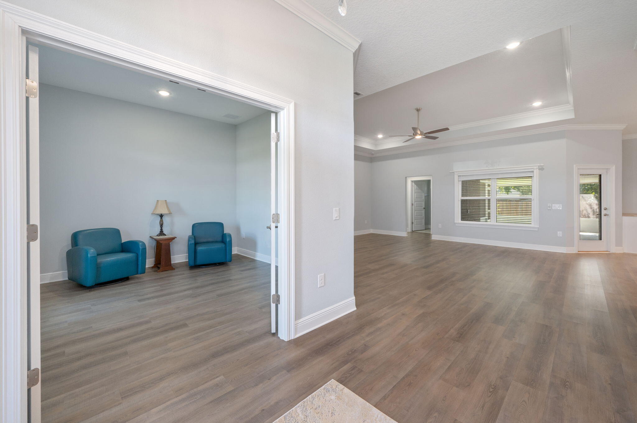 6125 Quintette Road Pace, FL 32571 - Photo 13 of 71 a view of an empty room with wooden floor and a window