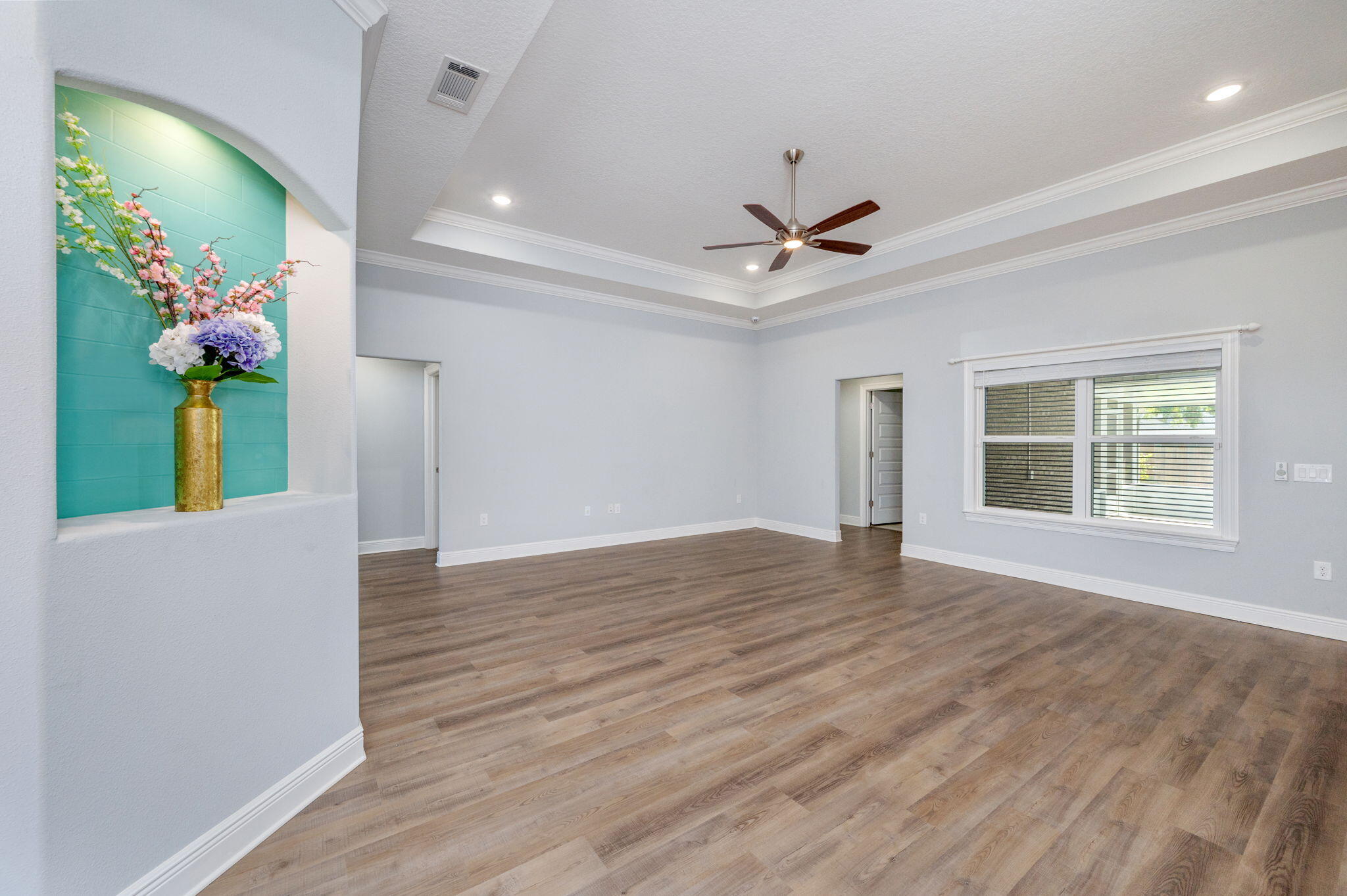 6125 Quintette Road Pace, FL 32571 - Photo 14 of 71 a view of an empty room with wooden floor and a window