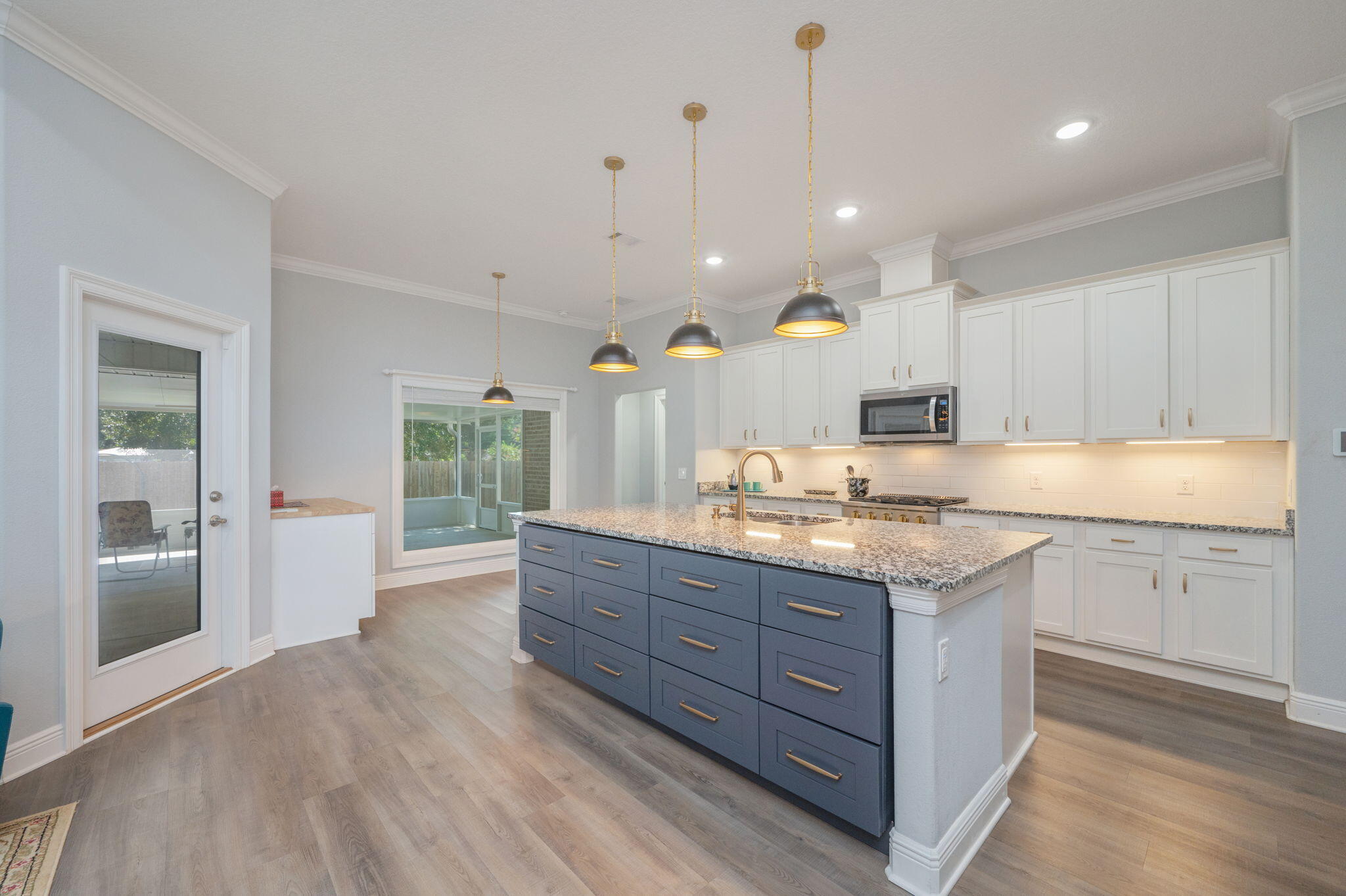6125 Quintette Road Pace, FL 32571 - Photo 18 of 71 a large kitchen with granite countertop a large island in the center a sink stainless steel appliances and cabinets