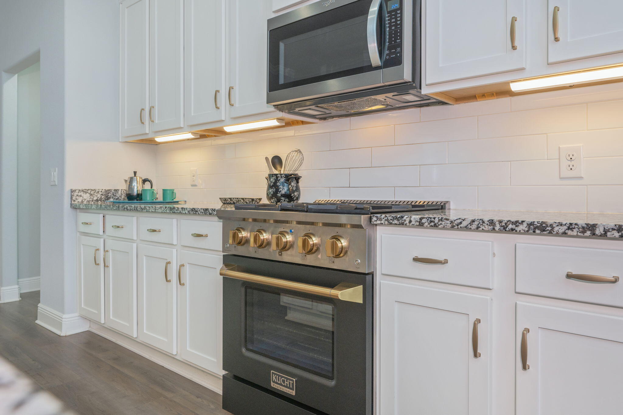 6125 Quintette Road Pace, FL 32571 - Photo 21 of 71 a kitchen with granite countertop white cabinets and stainless steel appliances