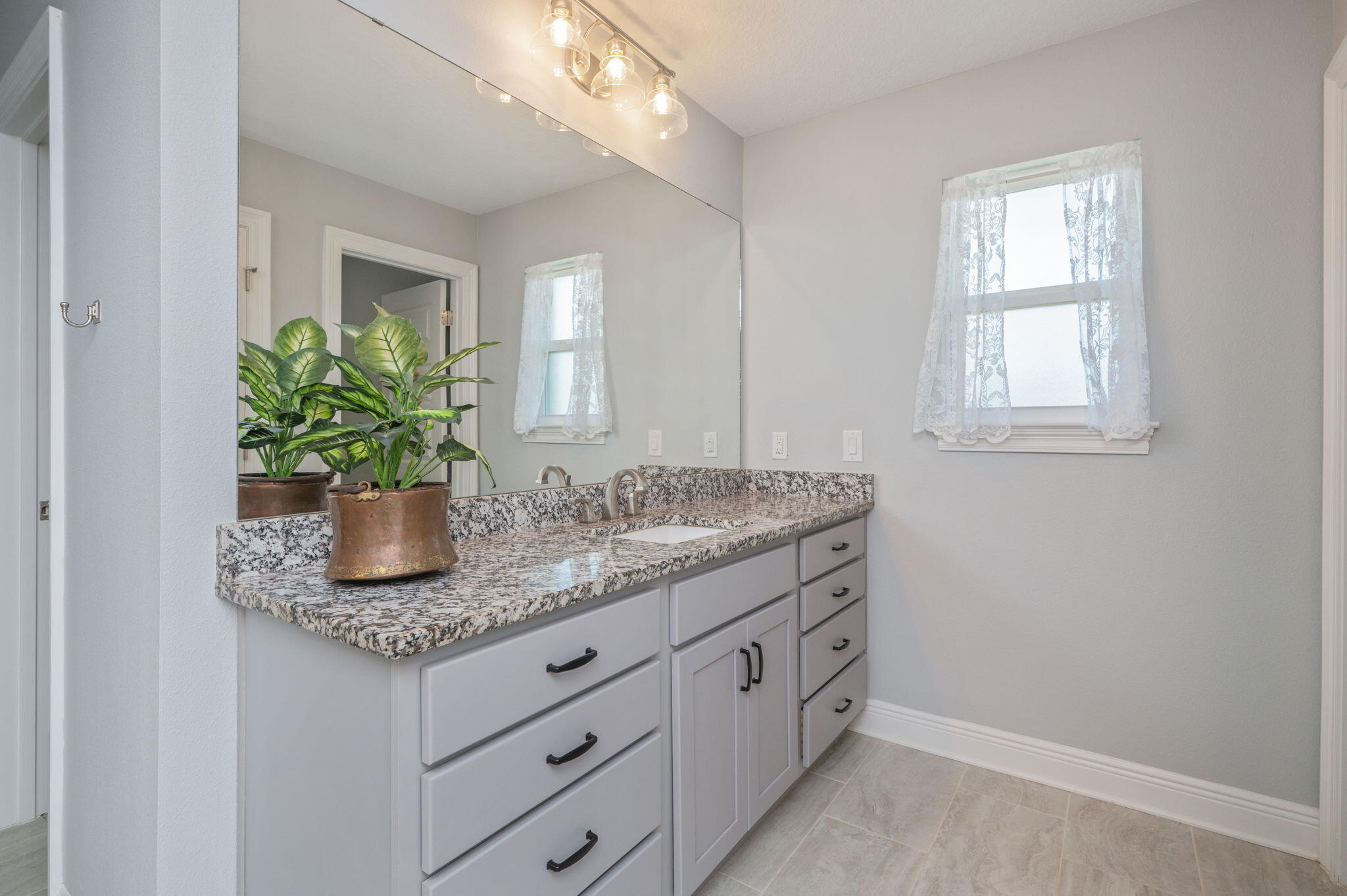 6125 Quintette Road Pace, FL 32571 - Photo 40 of 71 a bathroom with a granite countertop sink a mirror and a window