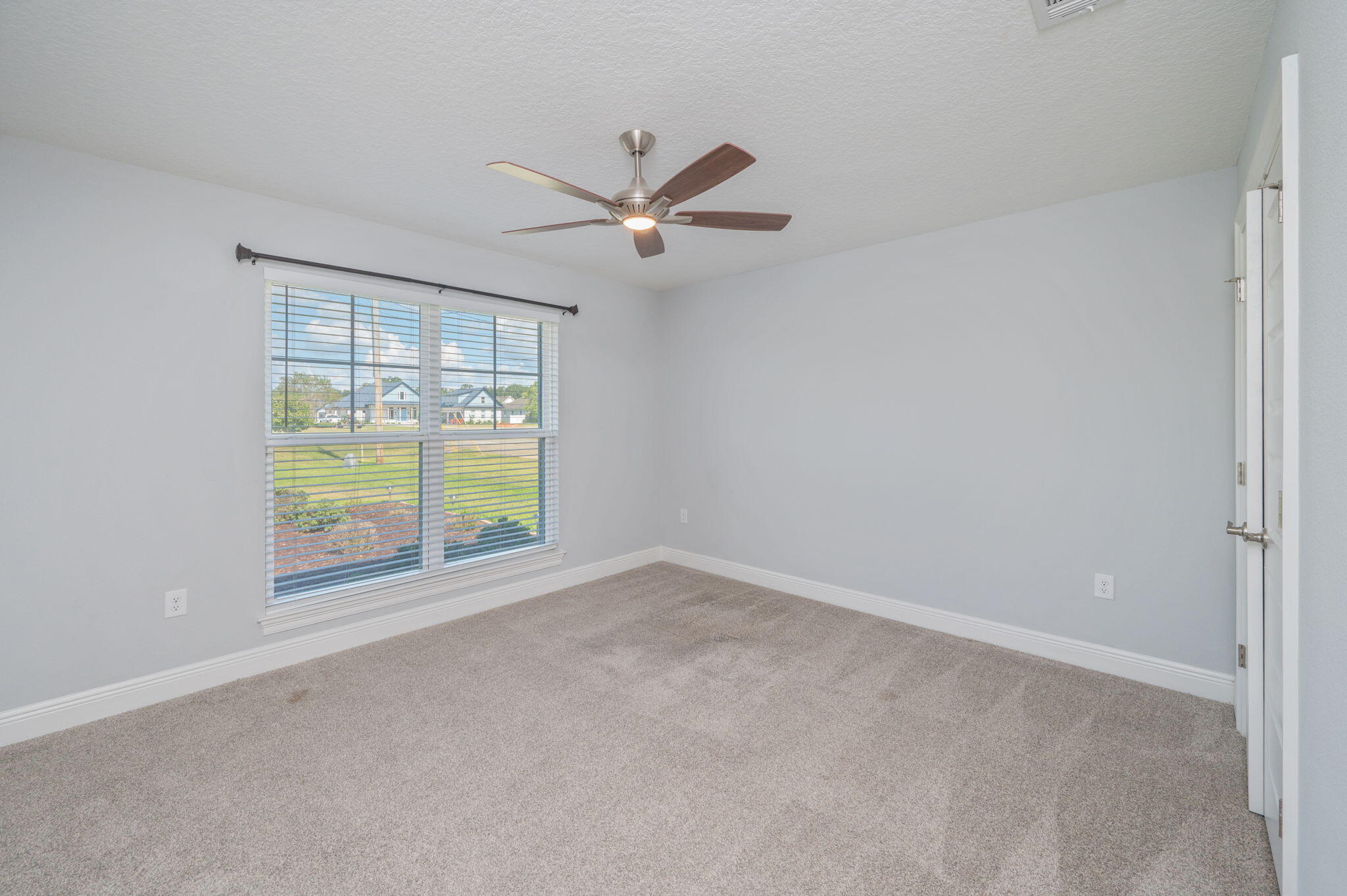 6125 Quintette Road Pace, FL 32571 - Photo 42 of 71 an empty room with windows and ceiling fan view