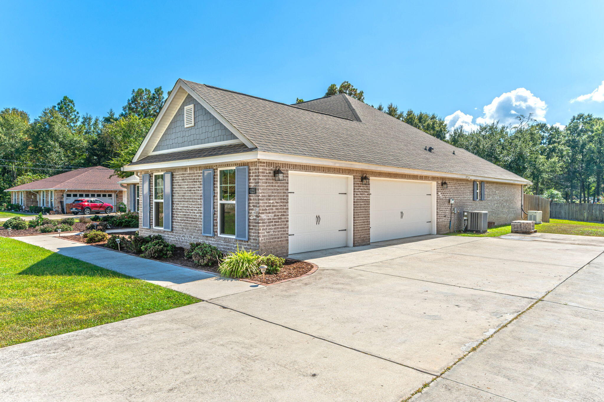 6125 Quintette Road Pace, FL 32571 - Photo 5 of 71 a front view of house with yard and trees in the background