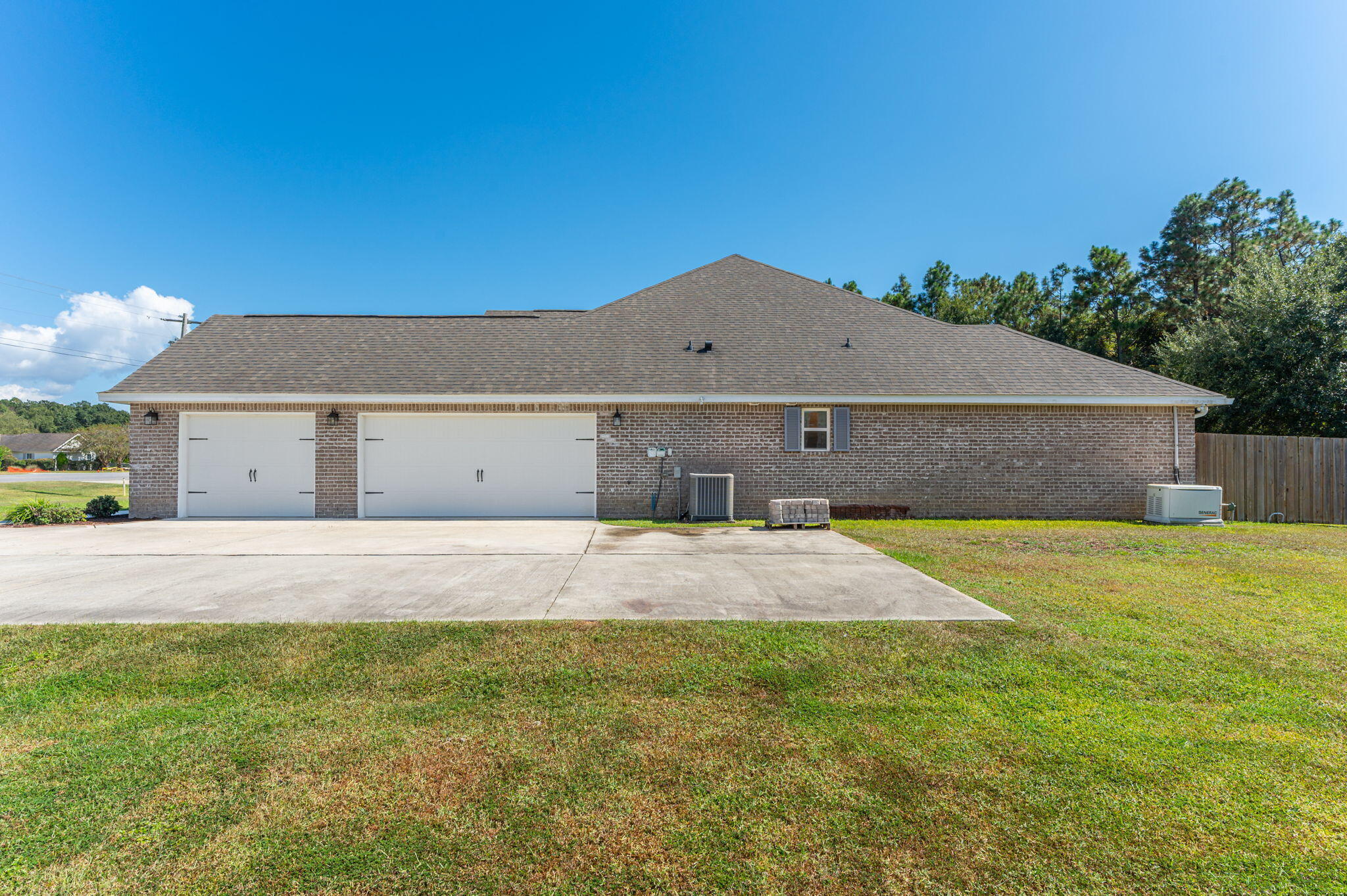 6125 Quintette Road Pace, FL 32571 - Photo 6 of 71 a front view of a house with a yard and garage