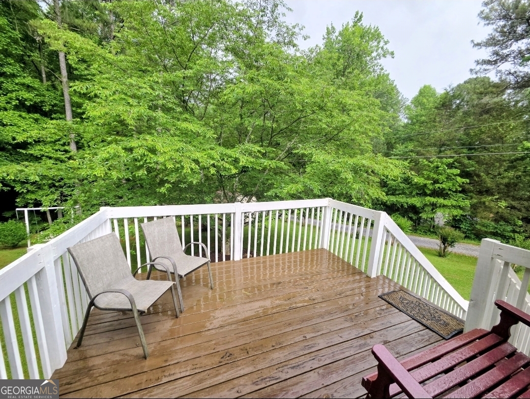 21 Baskin Heights Path Temple, GA 30179 - Photo 33 of 44 a balcony with wooden floor outdoor seating and trees