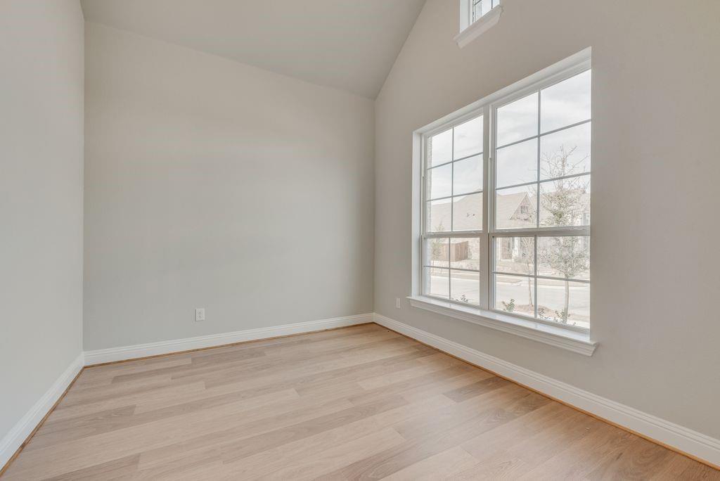 1259 Calebria Way Fate, TX 75087 - Photo 12 of 38 an empty room with wooden floor