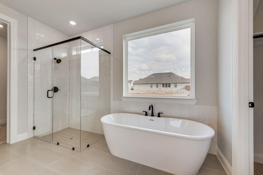1259 Calebria Way Fate, TX 75087 - Photo 17 of 38 a bathroom with a tub and a shower