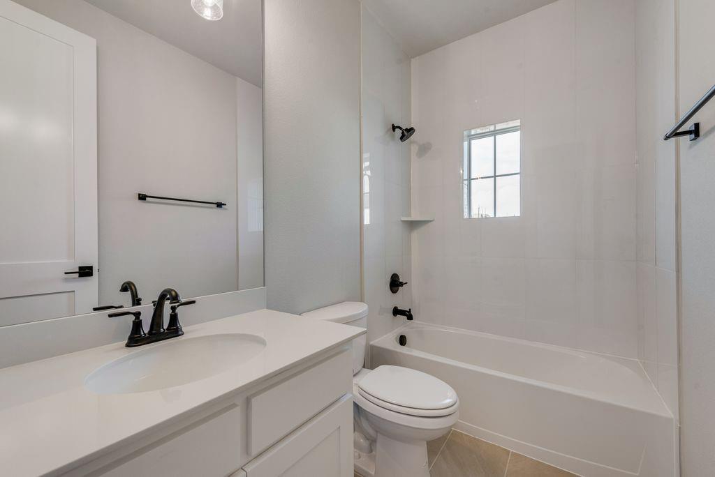 1259 Calebria Way Fate, TX 75087 - Photo 21 of 38 a bathroom with a sink a toilet and shower