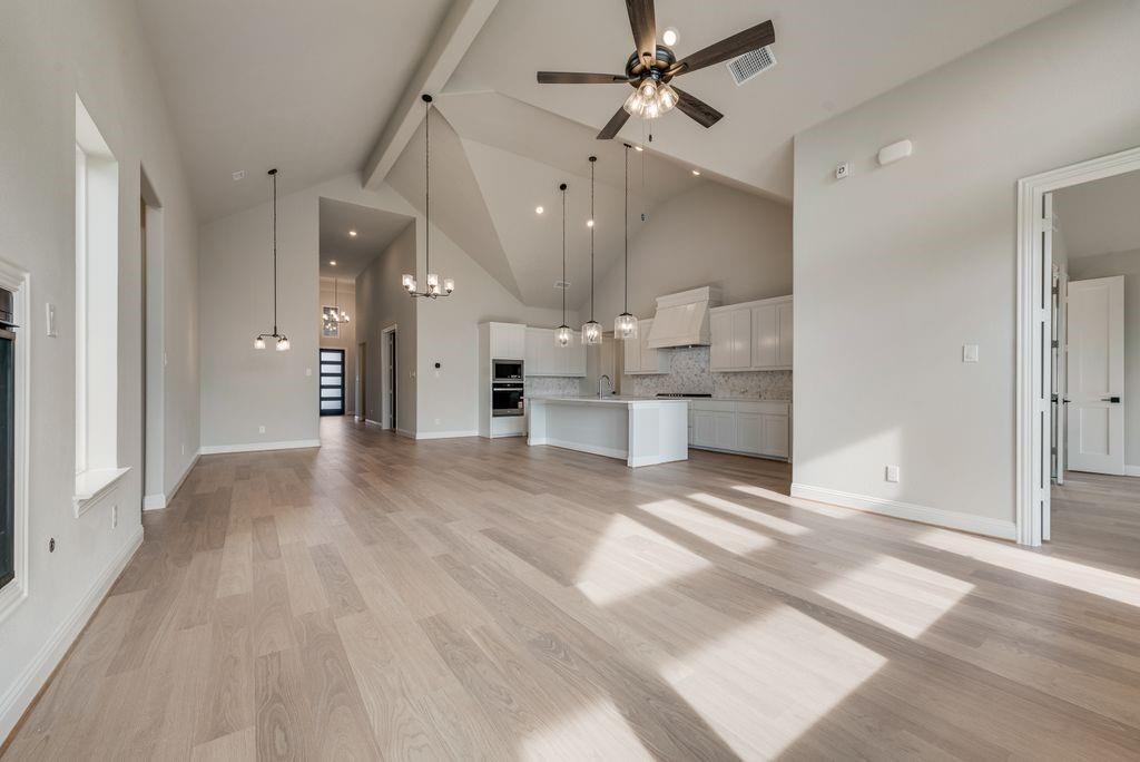 1259 Calebria Way Fate, TX 75087 - Photo 6 of 38 a view of a kitchen with wooden floor and a kitchen