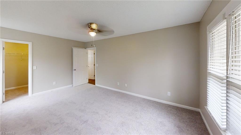 410 Shadybrook Road High Point, NC 27265 - Photo 15 of 43 Main level primary bedroom with walk-in closet and attached bathroom (behind bedroom entryway door). NEW carpet, NEW paint and NEW fan/ light.
