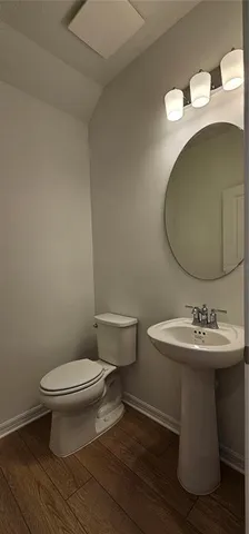 a bathroom with a sink toilet and mirror