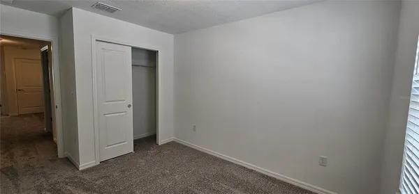 a large white kitchen with kitchen island a sink a stove and a refrigerator