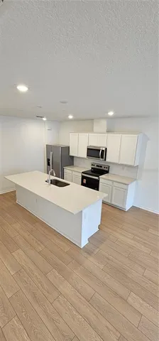 a kitchen with a sink and a refrigerator