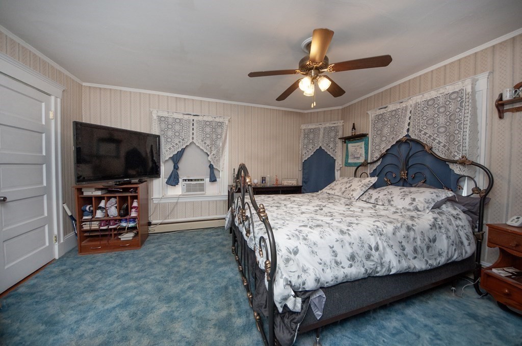 4 Fay Place Haverhill, MA 01830 - Photo 15 of 25 a bedroom with a bed and a flat tv screen on the dresser