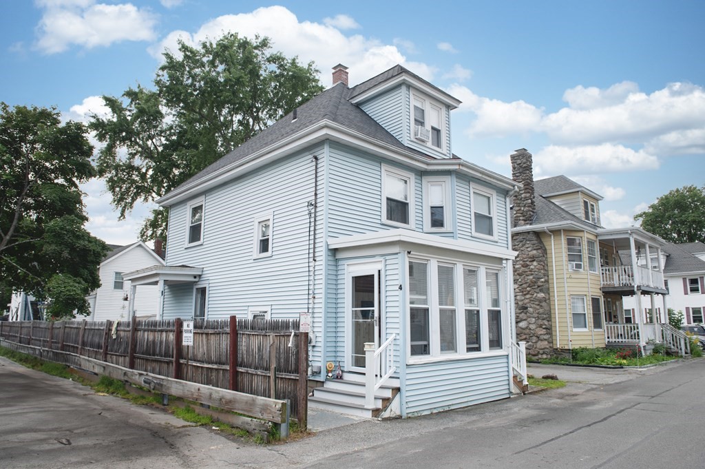 4 Fay Place Haverhill, MA 01830 - Photo 25 of 25 a view of a white house with large windows and a small yard