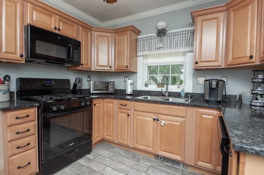4 Fay Place Haverhill, MA 01830 - Photo 5 of 25 a kitchen with stainless steel appliances granite countertop a stove sink microwave and cabinets