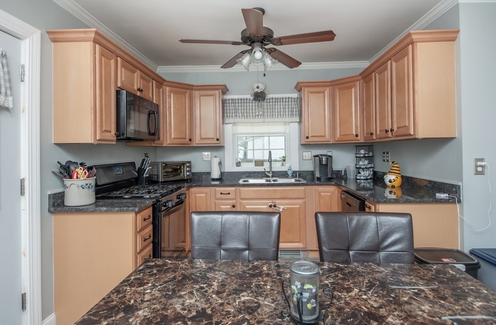4 Fay Place Haverhill, MA 01830 - Photo 6 of 25 a kitchen with stainless steel appliances granite countertop a stove a sink and a refrigerator