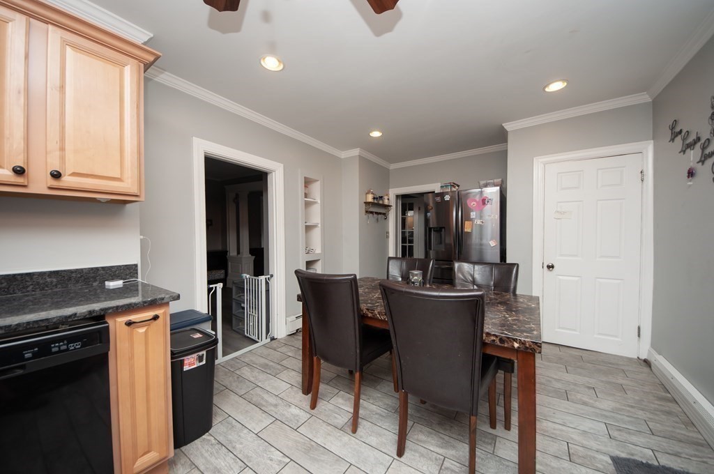 4 Fay Place Haverhill, MA 01830 - Photo 7 of 25 a kitchen with a dining table chairs and stainless steel appliances