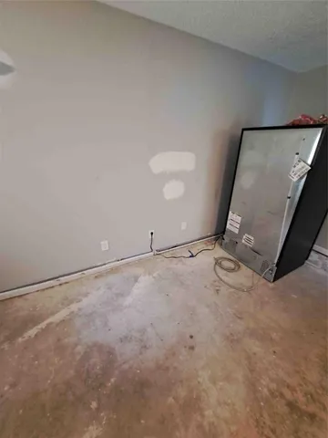 an empty room with an empty space and sink