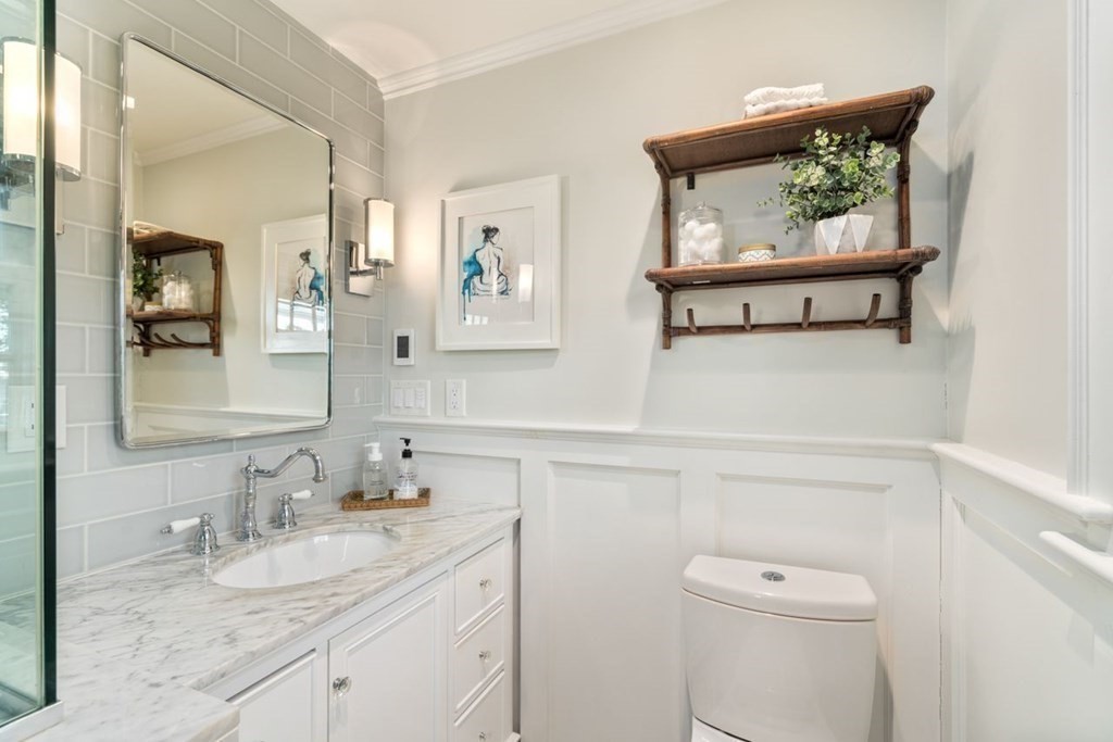 115 Bright Road Belmont, MA 02478 - Photo 14 of 22 a bathroom with a granite countertop sink a toilet and mirror