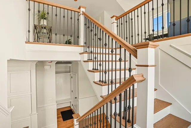 a view of staircase with railing and white walls