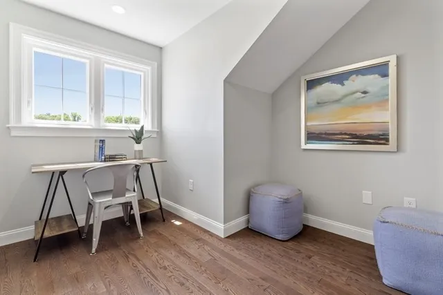 a workspace room with furniture and windows