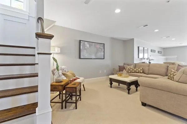a living room with furniture and a lamp