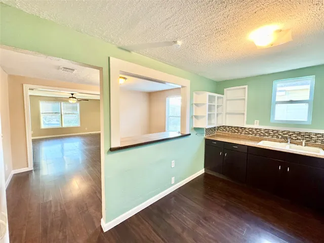 a view of a kitchen with kitchen island wooden floor and window