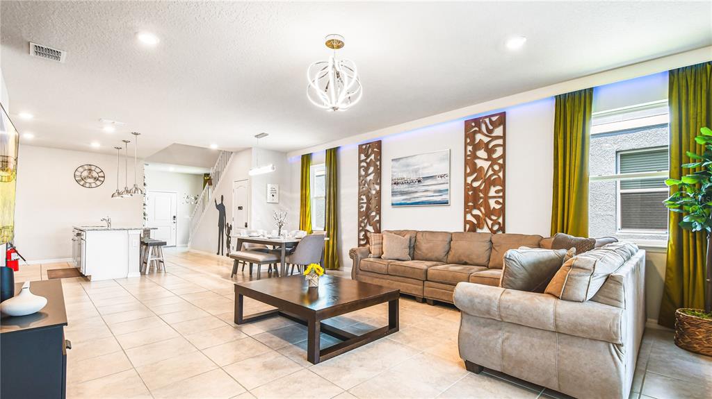 7219 Oakmoss Loop Davenport, FL 33837 - Photo 12 of 54 a living room with furniture and a large window